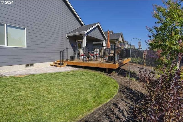 back of house featuring a wooden deck, fence, and a yard