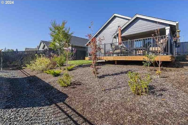 back of house with a fenced backyard and a deck