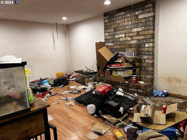 miscellaneous room with a textured ceiling and hardwood / wood-style floors