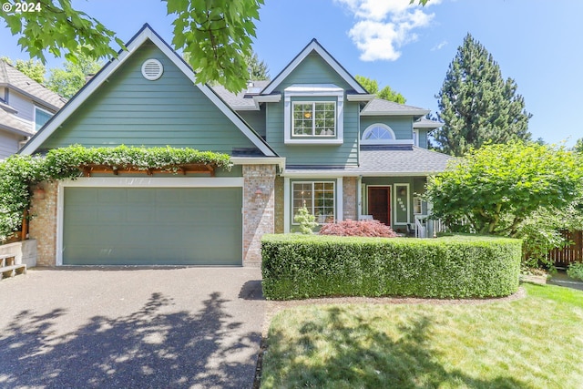 view of front of house featuring a garage and a front yard