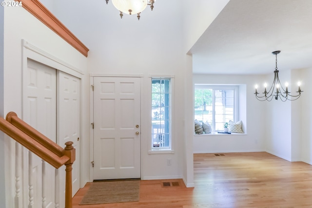 foyer featuring a notable chandelier and light hardwood / wood-style floors