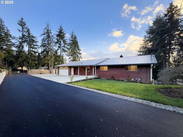 ranch-style home with a front yard and a garage