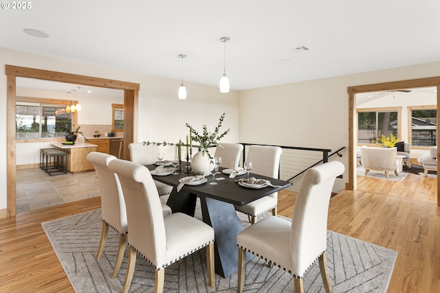 dining space featuring a chandelier and light hardwood / wood-style flooring