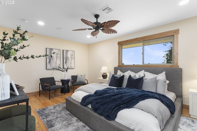 bedroom with ceiling fan and hardwood / wood-style flooring