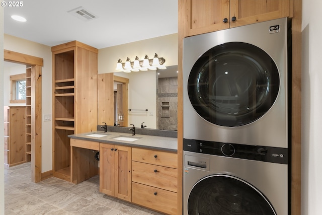 laundry area with sink and stacked washer and dryer