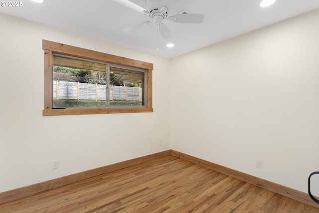 empty room with hardwood / wood-style floors and ceiling fan