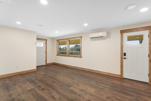 interior space featuring dark hardwood / wood-style flooring and a wall unit AC