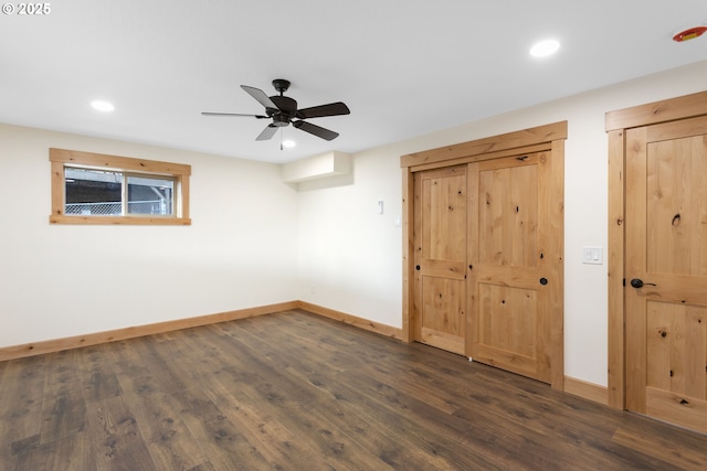 unfurnished bedroom with ceiling fan and dark hardwood / wood-style floors