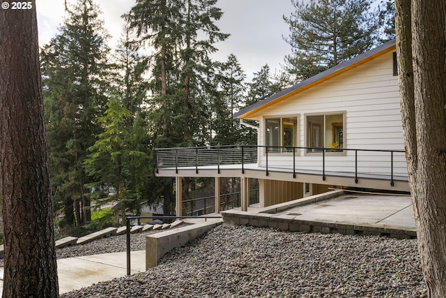 view of property exterior with a patio area