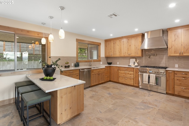1017 Columbia Ridge Dr, Vancouver, WA 98664 - kitchen featuring wall chimney exhaust hood, stainless steel appliances, a peninsula, light countertops, and recessed lighting