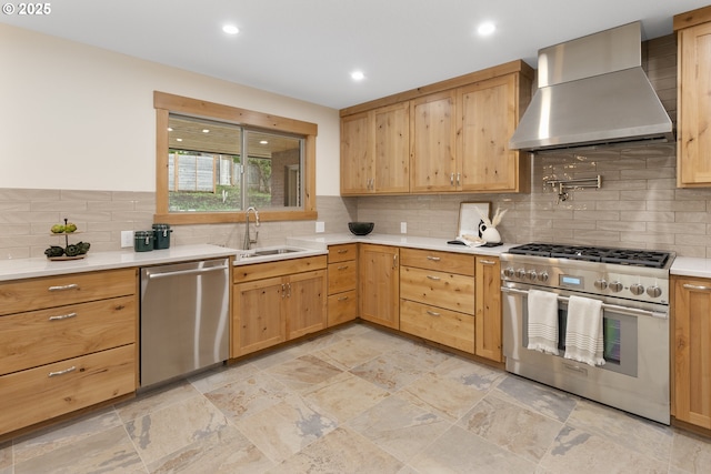 1017 Columbia Ridge Dr, Vancouver, WA 98664 - kitchen with appliances with stainless steel finishes, wall chimney exhaust hood, a sink, light countertops, and backsplash