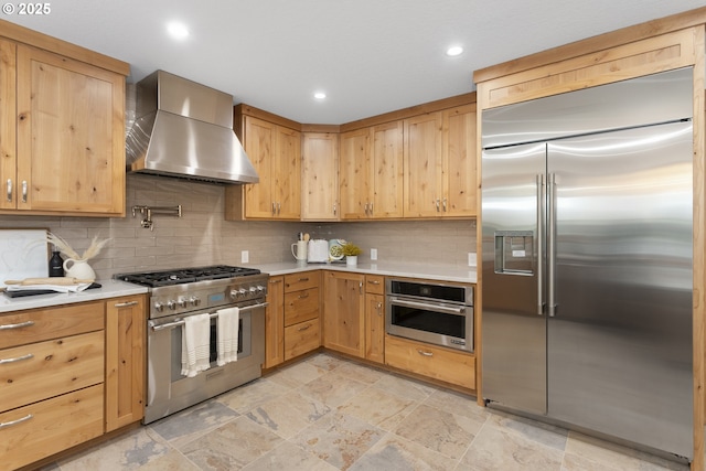 1017 Columbia Ridge Dr, Vancouver, WA 98664 - kitchen with high end appliances, wall chimney range hood, light countertops, light brown cabinets, and decorative backsplash