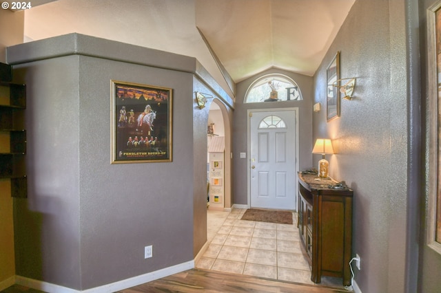 entrance foyer featuring vaulted ceiling and light hardwood / wood-style floors