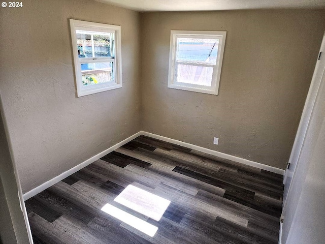 spare room with dark hardwood / wood-style floors