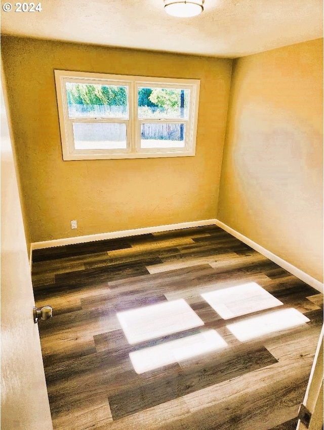 empty room featuring dark hardwood / wood-style floors