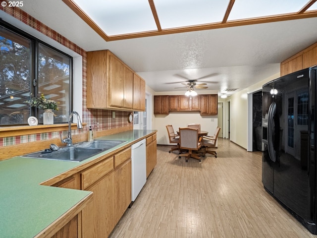 kitchen with sink, light hardwood / wood-style flooring, dishwasher, backsplash, and black fridge with ice dispenser