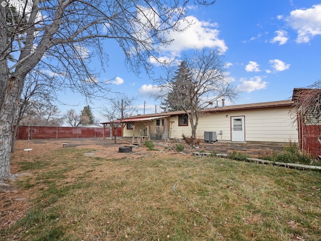 back of house featuring a lawn and central air condition unit