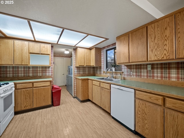 kitchen featuring sink, backsplash, white appliances, and light wood-type flooring