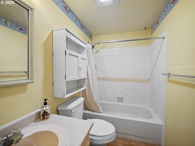 full bathroom with toilet, shower / tub combo, a textured ceiling, vanity, and hardwood / wood-style floors