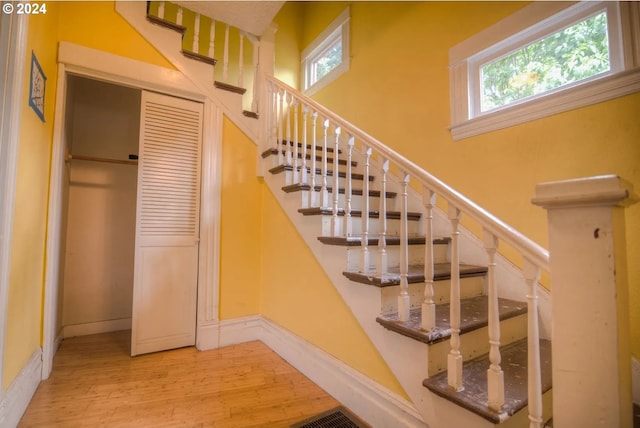 stairs featuring hardwood / wood-style floors