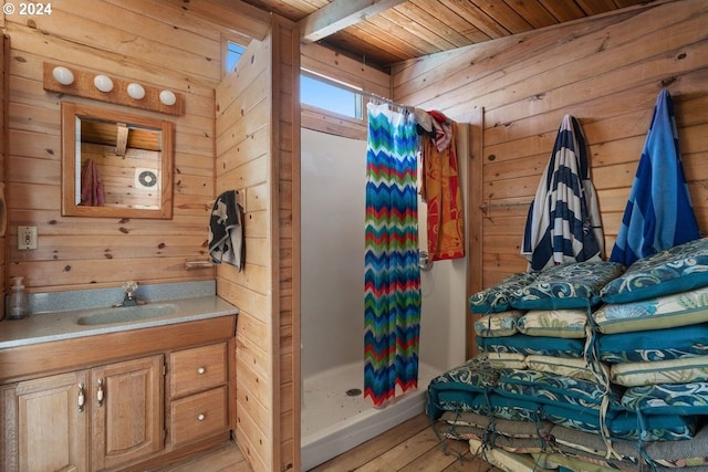 bathroom featuring hardwood / wood-style floors, vanity, a shower with curtain, wooden walls, and wood ceiling