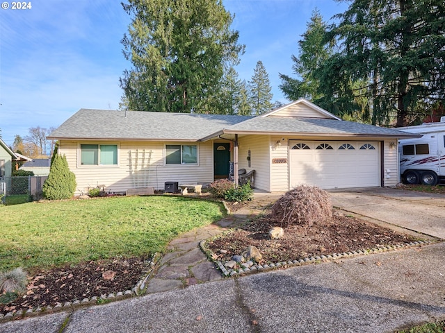 ranch-style home with a garage and a front lawn