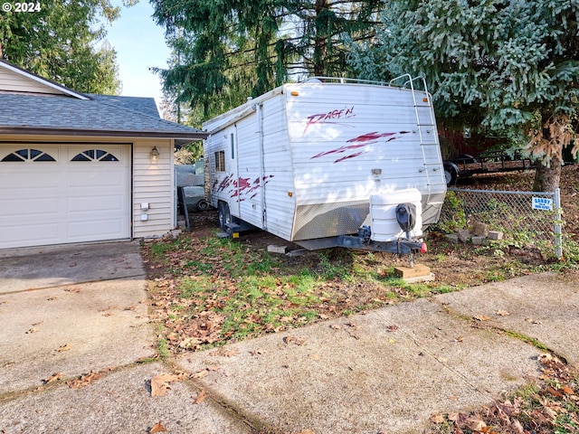 view of side of property featuring a garage and an outdoor structure