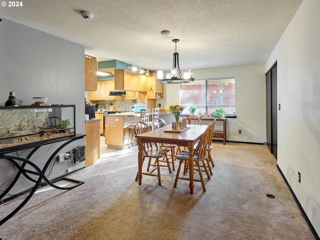 dining space featuring a notable chandelier, light colored carpet, and a textured ceiling