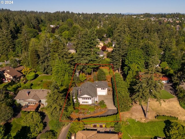 birds eye view of property featuring a wooded view