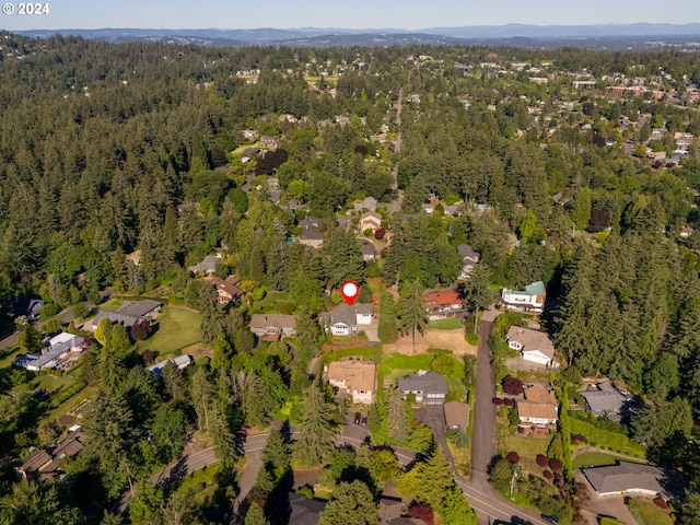 drone / aerial view with a residential view and a wooded view