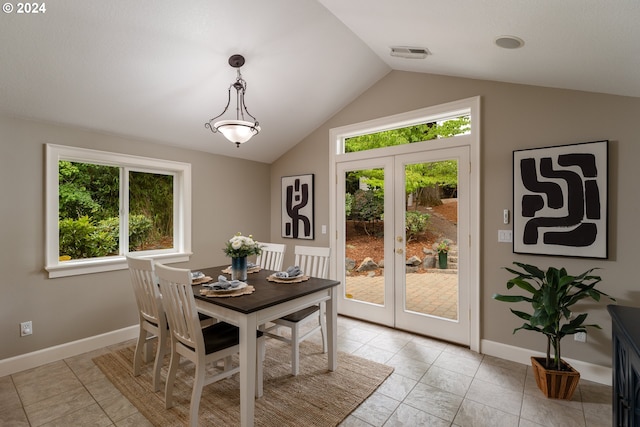 dining area featuring visible vents, lofted ceiling, baseboards, and french doors