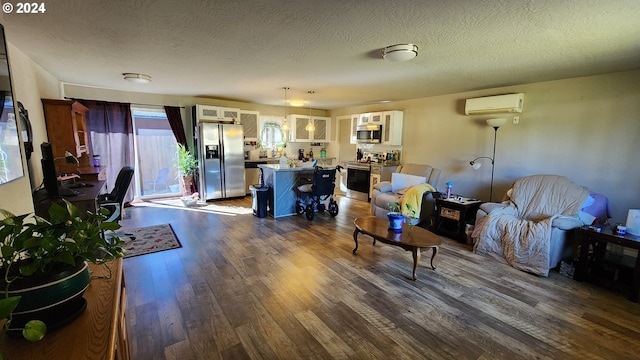 living room with a textured ceiling, dark hardwood / wood-style floors, and a wall mounted AC