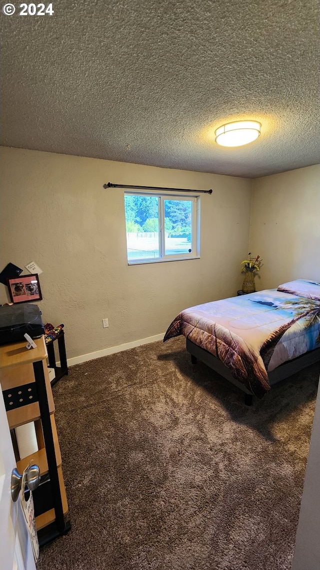 carpeted bedroom featuring a textured ceiling