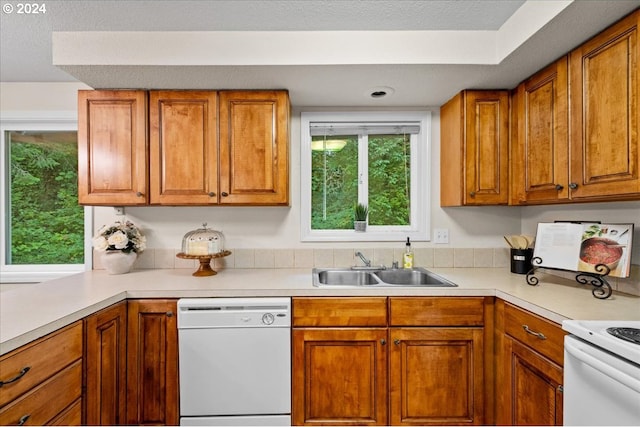 kitchen featuring white dishwasher, a textured ceiling, and sink