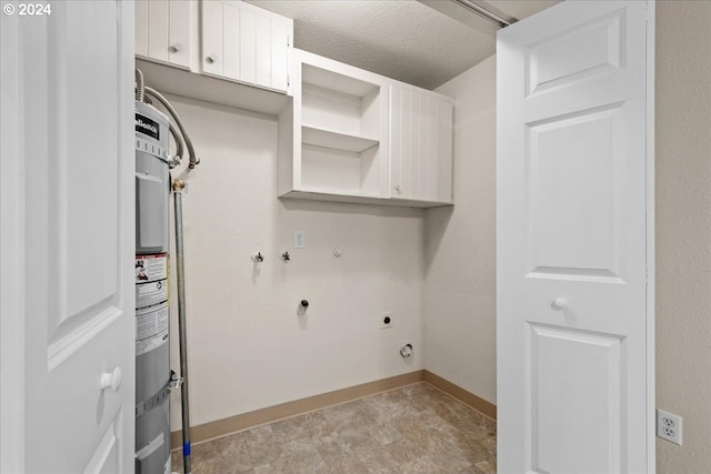 laundry area featuring cabinets, hookup for an electric dryer, a textured ceiling, and gas dryer hookup