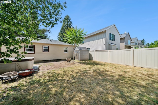 rear view of house with a shed and a lawn