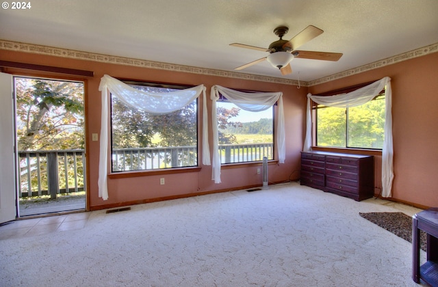 carpeted empty room featuring ceiling fan