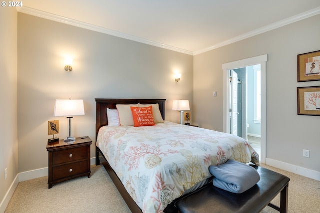 bedroom featuring light colored carpet, ensuite bath, and crown molding