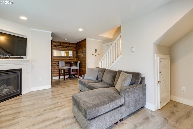 living room with wood walls and light hardwood / wood-style flooring