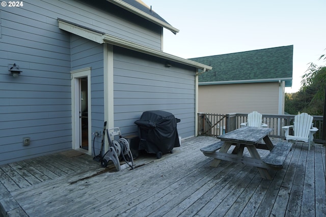 wooden terrace with a grill