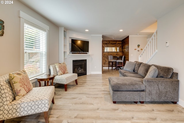 living room with a large fireplace and light hardwood / wood-style floors