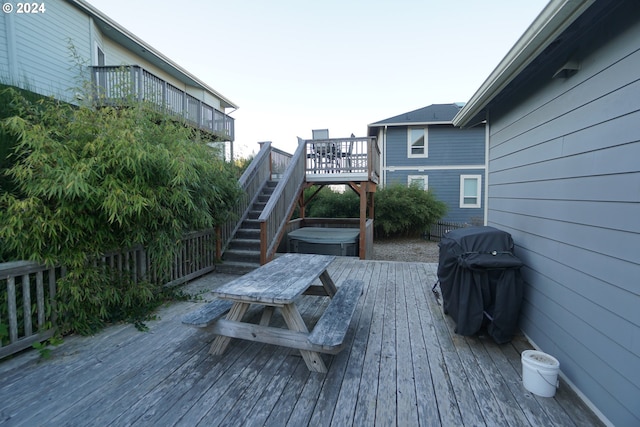 deck with a hot tub and grilling area