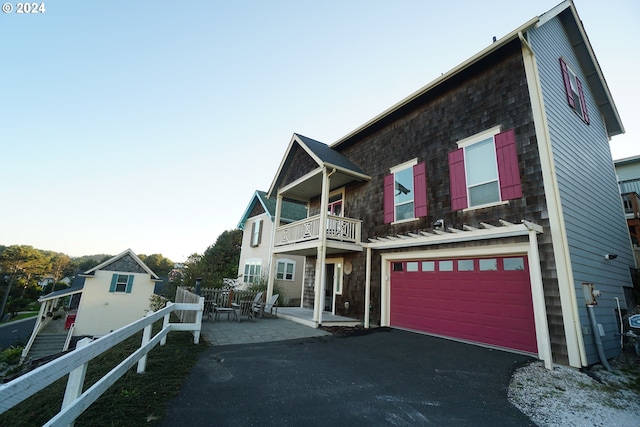 view of front of property with a garage and a balcony