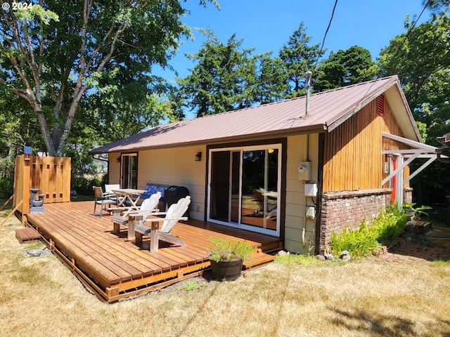 rear view of property with metal roof and a deck