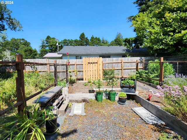 view of yard featuring fence private yard and a vegetable garden