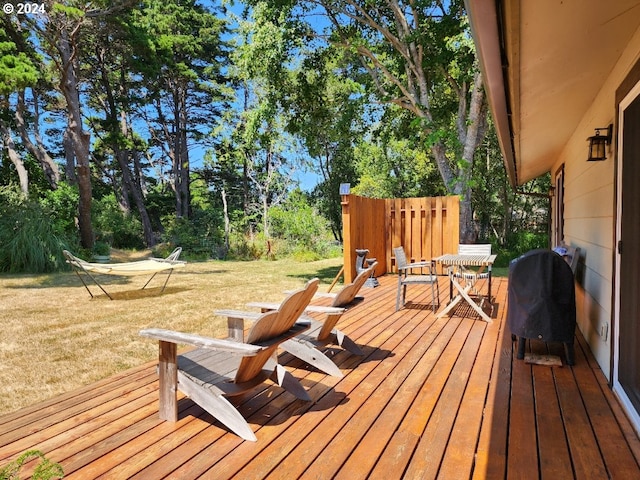 wooden deck with a lawn and grilling area