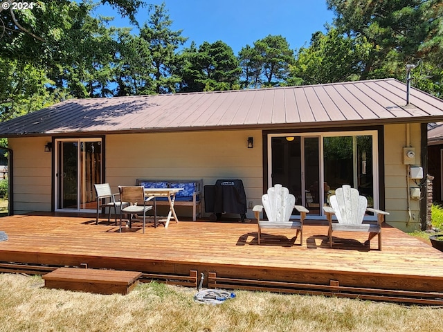 back of property with a deck and metal roof
