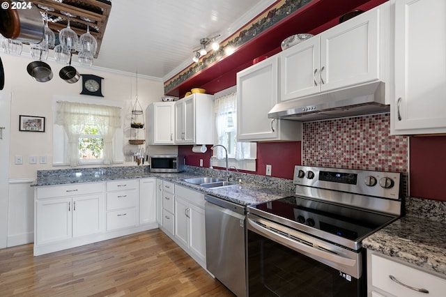 kitchen featuring white cabinetry, appliances with stainless steel finishes, sink, and light hardwood / wood-style flooring