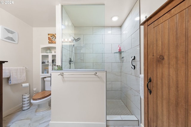 bathroom with toilet and a tile shower