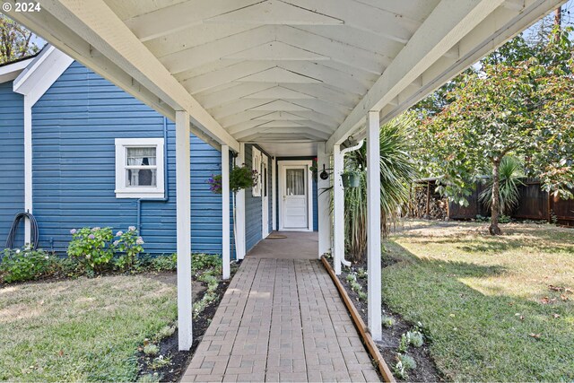 doorway to property featuring a yard